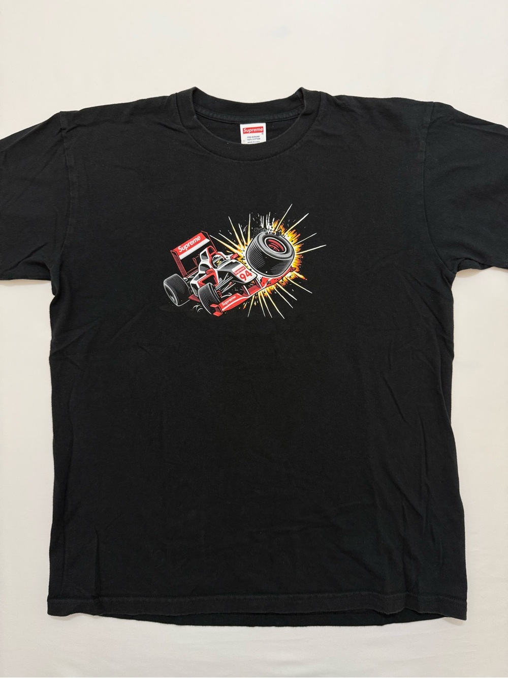 Supreme Black Tee with Red Racing Car Graphic
Men’s Medium